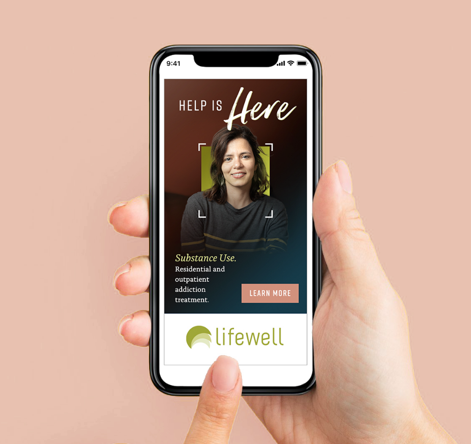 lifewell holding cell phone